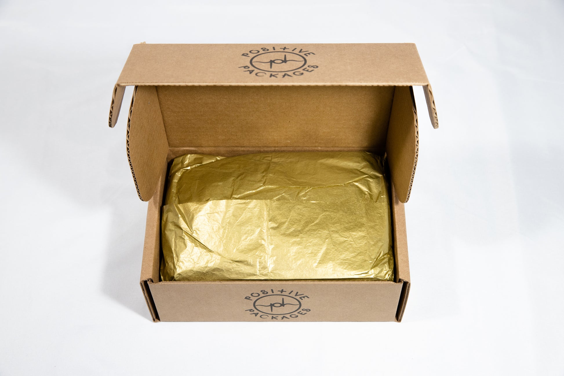 Gold tissue paper wraps each Pampering Positive Package and its content to remind us how truly valuable we all are!